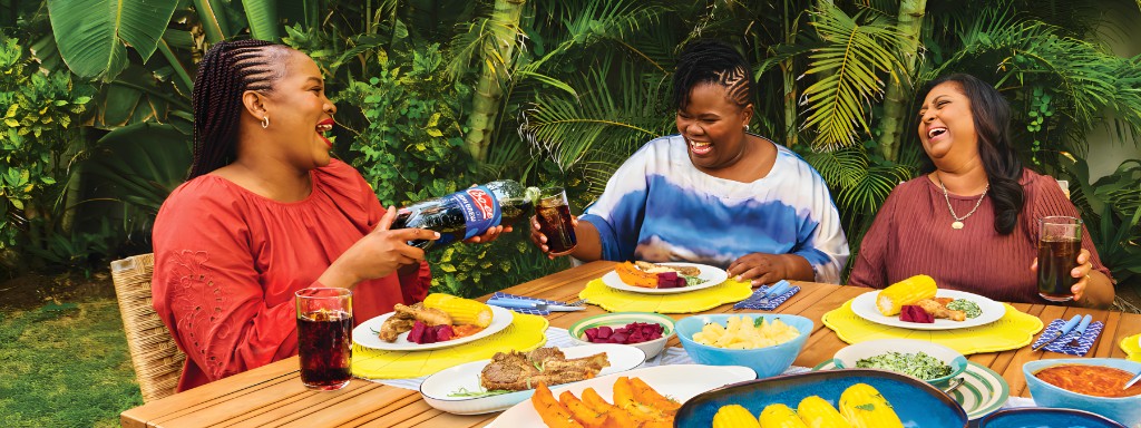 Friends sharing Coo-ee at an outdoor meal